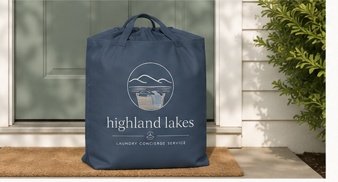 Highland Lakes Laundry tote bag at a front door